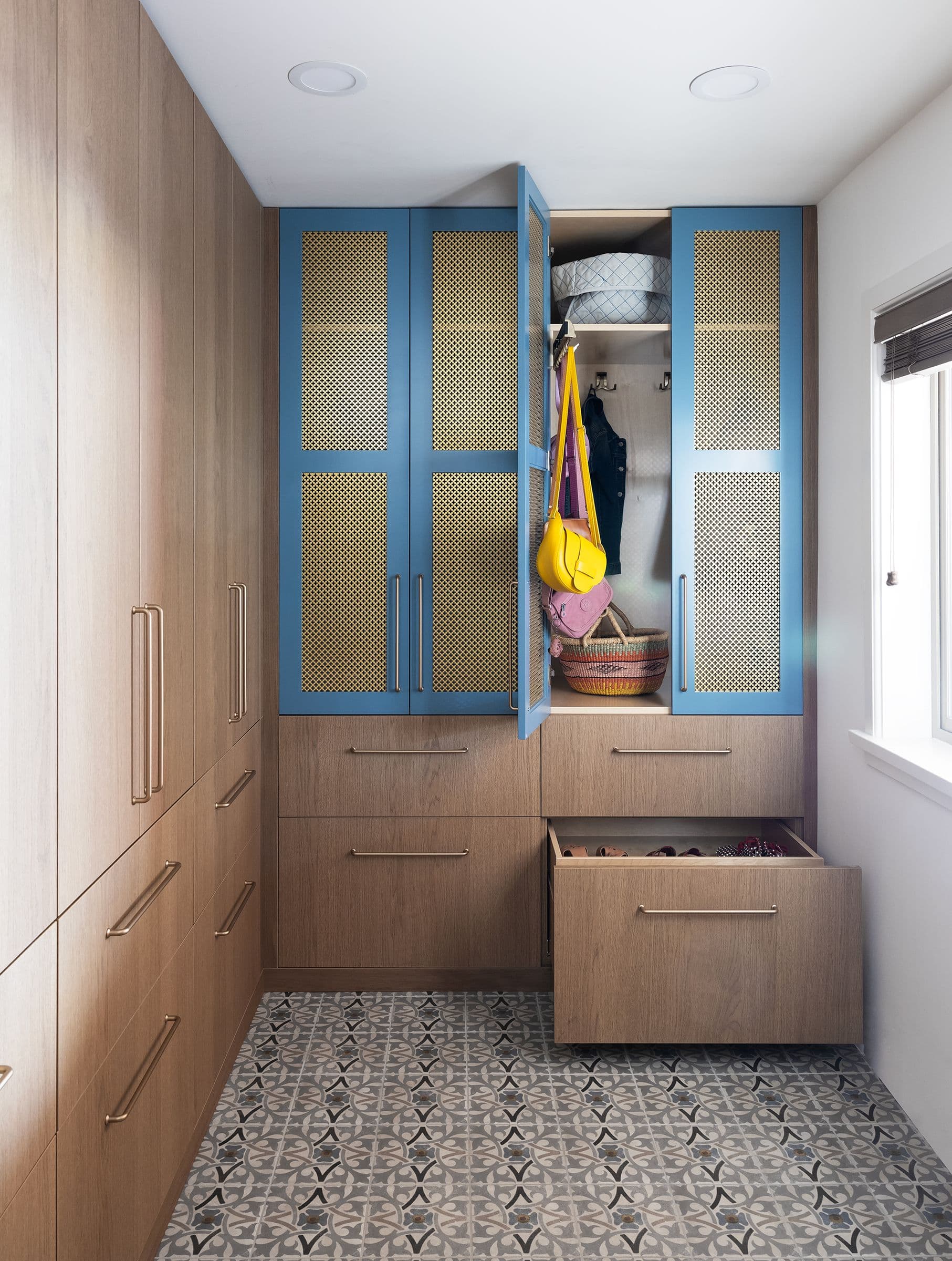 Mudroom with blue mesh-front cabinets open, the Blue Mudroom