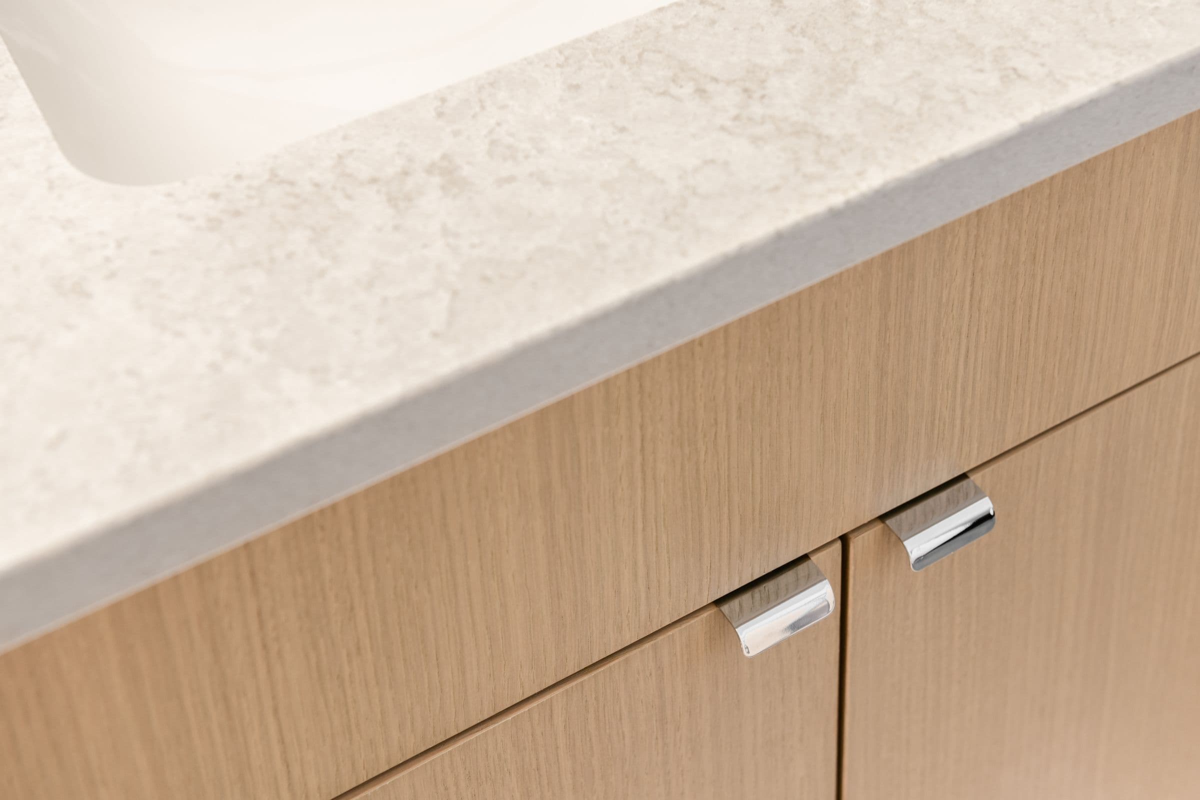 Quartz counter meeting white-oak fronts, detail